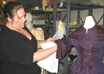 Camille Breeze, Chief Conservator at Museum Textile Conservation, prepares an exhibition for the Andover Historical Society